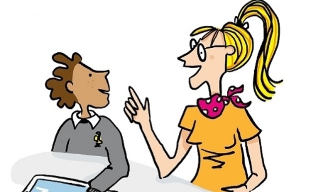Teaching assistant supporting children in a primary school classroom